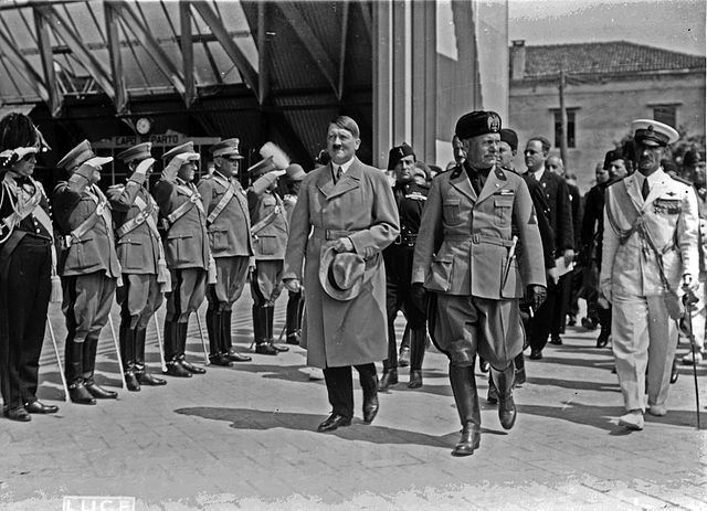 (Adolf Hitler walking with Mussolini during a state visit to Venice in 1934, public domain, Library of Congress's Prints and Photographs division)